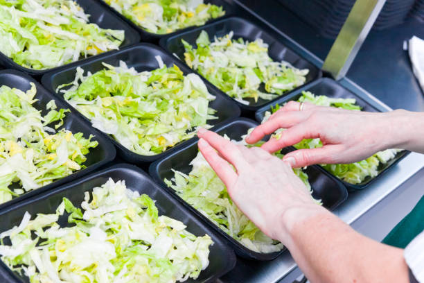 Convenience food sliced iceberg lettuce in portion bowls stock photo