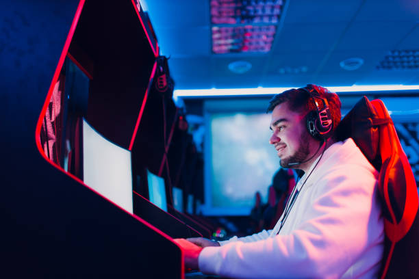istock Guy playing gaming game on computer at game club 1367496179