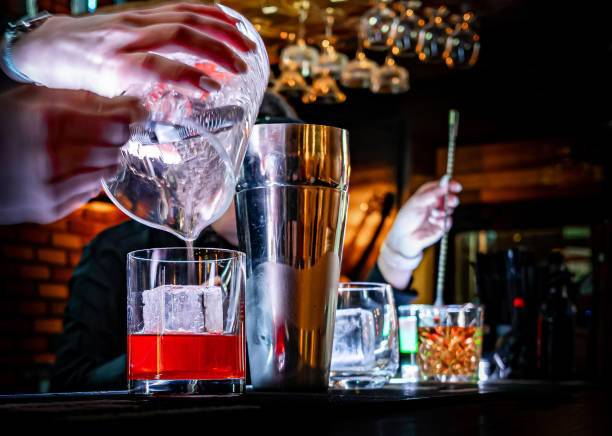 istock bartender hand making cocktail in glass on bar counter 1367496247