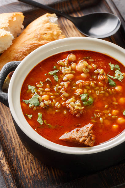 Chorba frik is a variant of a very traditional soup Maghreb consumed in Algeria, Tunisia and Libya close-up on the table. Vertical Chorba frik is a variant of a very traditional soup Maghreb consumed in Algeria, Tunisia and Libya close-up in a plate on the table. Vertical libyan culture stock pictures, royalty-free photos & images