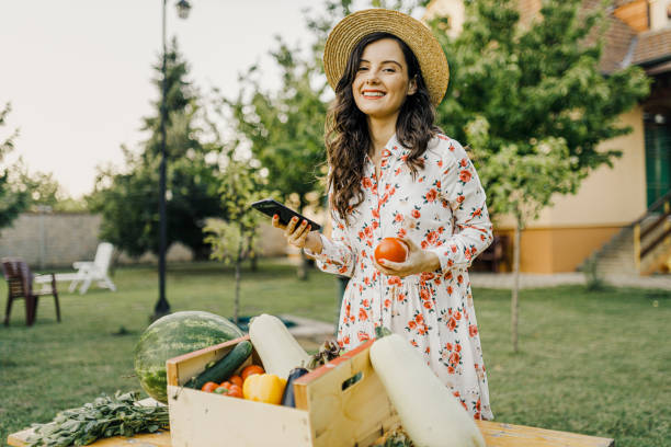 istock Female farmer using her smart phone and selling organic vegetables 1367497970