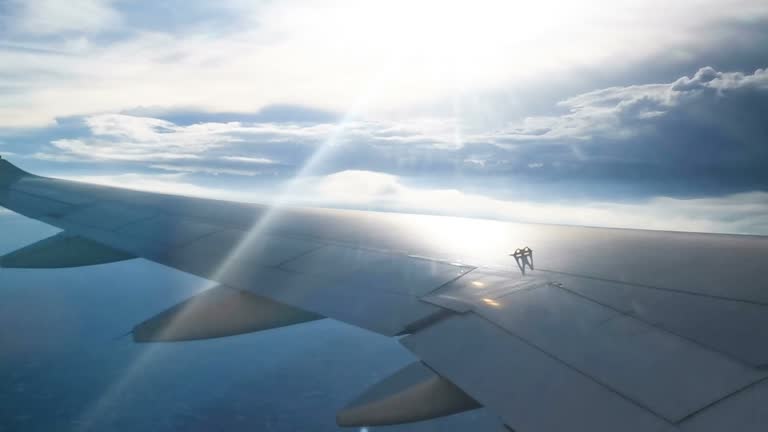 flying and traveling, view from airplane window on the wing on sunset time