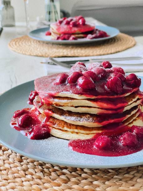 Pancakes with cherry syrup stock photo