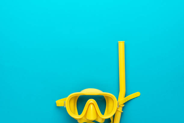 istock yellow diving mask and snorkel over blue background with copy space 1367501122