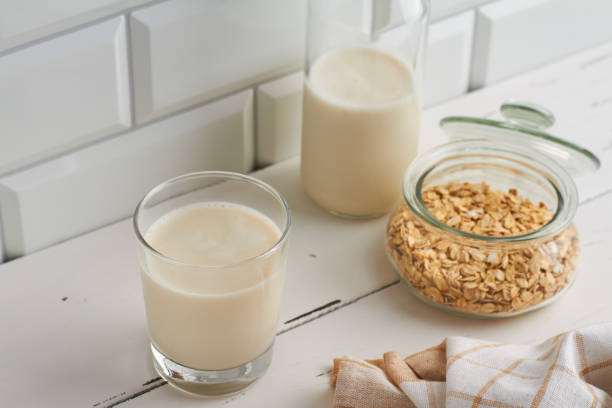 istock oat milk in a glass oat flakes milk bottle white background 1367501621