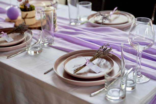 Table setting with sparkling wineglasses, plate and cutlery on table, copy space. Place set at wedding reception. Table served for wedding banquet in restaurant stock photo