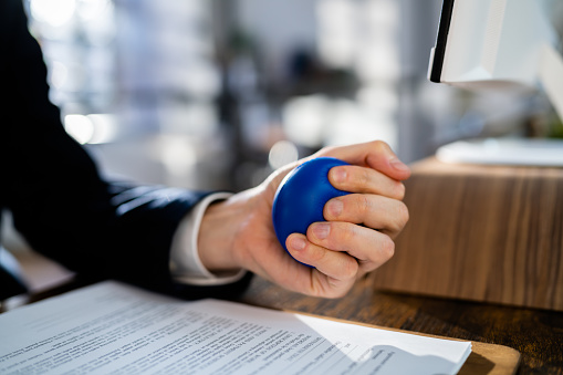 Close-up Of Businessman Holding Stress Ball In Hand