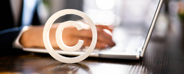 istock Copyright Sign Near Man's Hand Working 1367507679