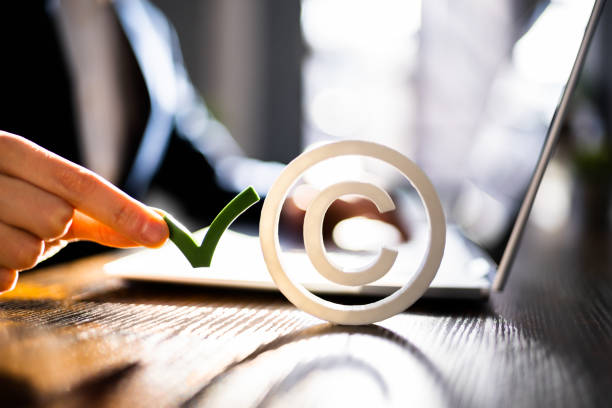 istock Copyright Sign Near Man's Hand Working 1367507689