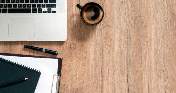 istock Creative workspace background. Top view image of laptop computer, cup of coffee and clipboard on wooden background with copy space. 1367508695