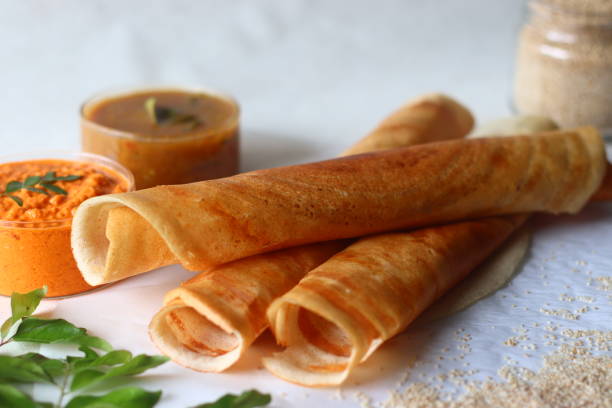 crispy crepes made of little millets and lentils. commonly known as little millet dosa. plated as dosa rolls. served with coconut spicy condiments and sambar - dosa imagens e fotografias de stock