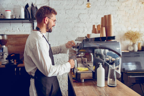 istock Male barista using professional coffee machine in cafe 1367511064