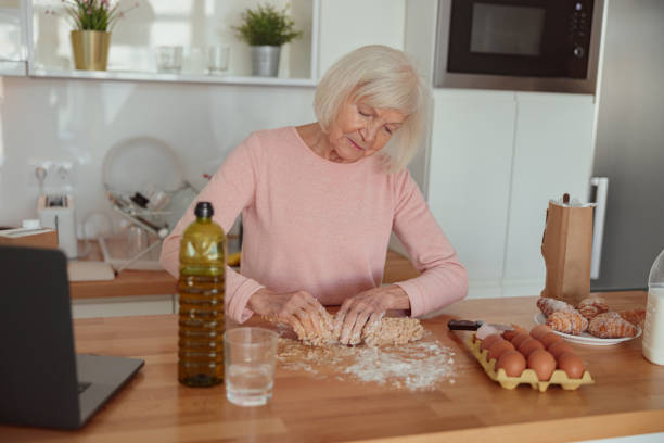 istock Skillful retired woman enjoying cooking at home 1367511657