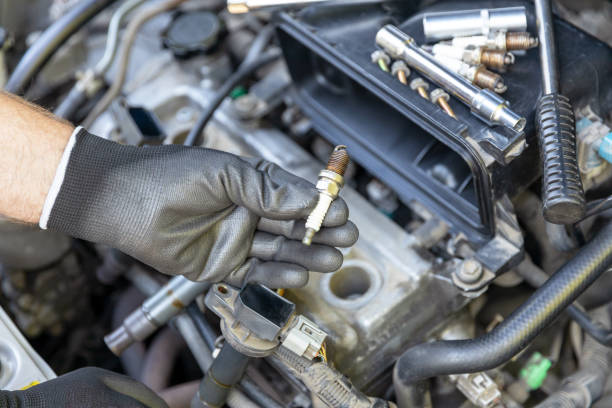 istock Car spark plug replacement. Repairing of vehicle. 1367513881