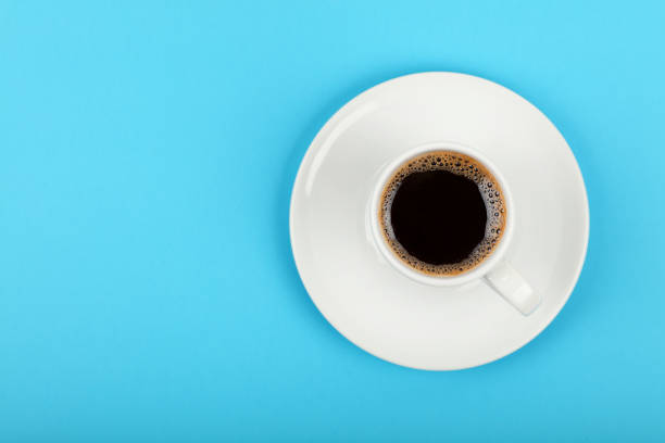 istock Full white espresso coffee cup over blue 1367515674