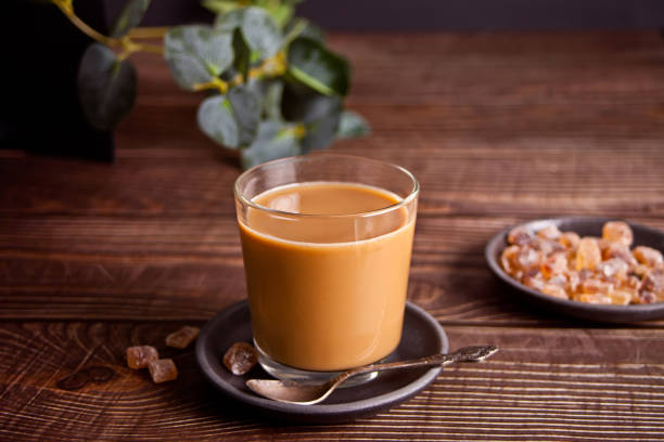 istock Glass of milky coffee with rock candy sugar. 1367516562