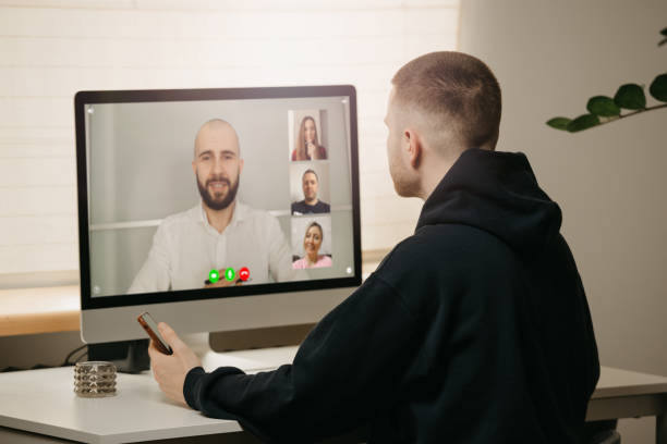 istock A back view of a man during a video call with his colleagues on the computer. 1367516848
