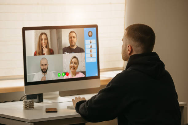 istock A back view of a man during a video call with his colleagues on the computer. 1367516855