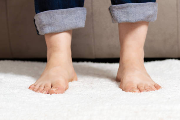 istock barefoot woman at home 1367518125