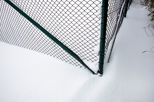 Wire mesh fence covered with snow