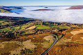 Aerial view of low level fog and cloud in a valley in the rural Brecon Beacons, Wales