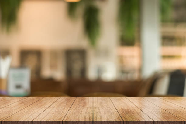 istock Empty wooden table top with lights bokeh on blur restaurant background. 1367524819