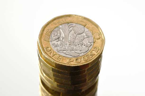 istock Column of one pounds coins reflected in a mirror 1367526181