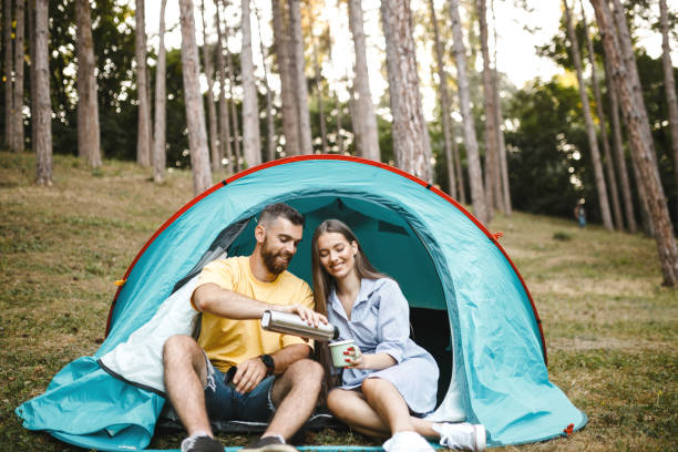 istock Couple relax in camping tent on summer vacation 1367528712