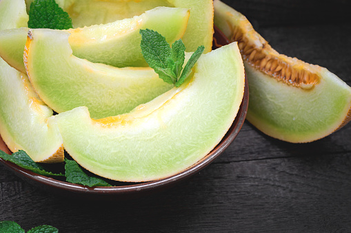 Sweet and juicy melon on plate, slices of cantaloupe close up