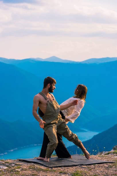 istock Happy romantic couple dancing open air under blue sky 1367531541