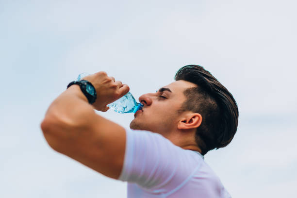istock Sporty Caucasian man drinking water after gym training 1367532497
