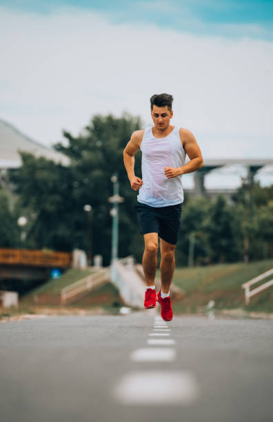 istock Young Caucasian man running outdoors in park 1367532635