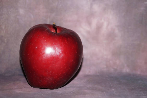 istock red apple on dark vintage background, copy space 1367533989