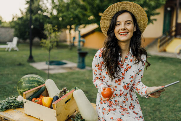 istock Smiling Female farmer using her digital tablet and selling organic vegetables 1367534920