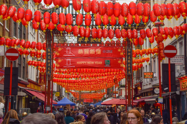 Lunar New Year decorations in Chinatown, London, UK London, UK 29th January 2022. New red lanterns and 'Happy New Year' signs decorate Chinatown ahead of the Lunar New Year/Chinese New Year. This year marks the Year of the Tiger. new year urban scene horizontal people stock pictures, royalty-free photos & images