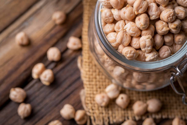 istock Dried raw chickpea on the wooden background 1367538765