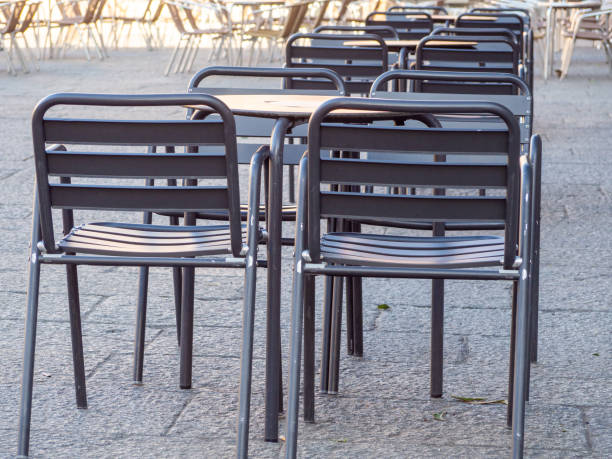 istock Empty chairs and tables at closed outdoor restaurant 1367539630