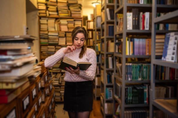 istock young student after graduation comes to the library to learn new knowledge. 1367540196