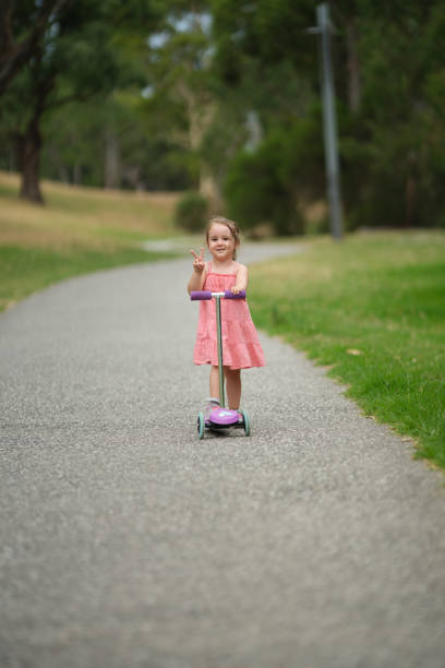 Little cute girl possing with scooter