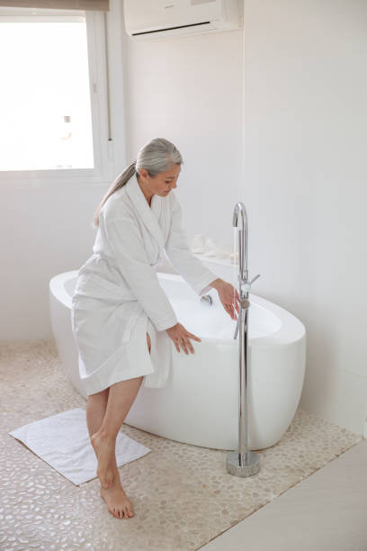 istock Beautiful slender woman preparing bath in spa 1367543556