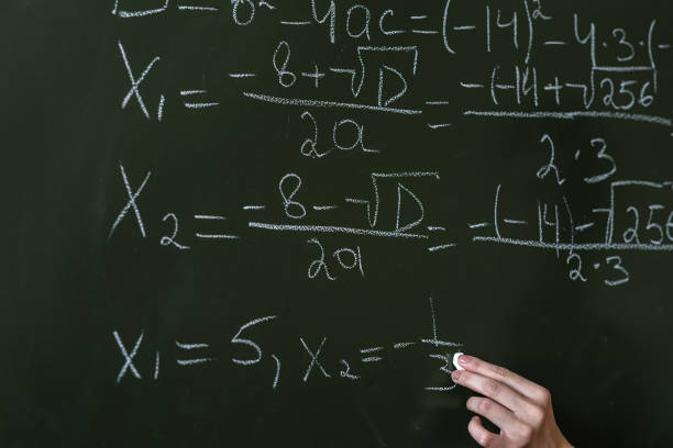 istock schoolgirl writing high school math's formula  with chalk on blackboard 1367544985