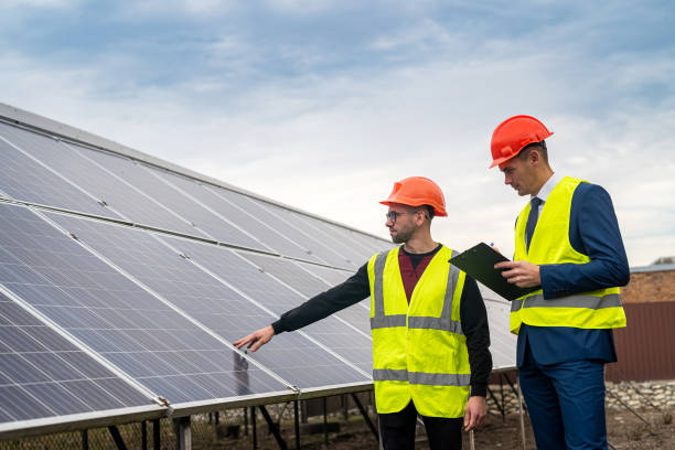 istock two professionals in workwear discuss solar panels and their impact. 1367546591