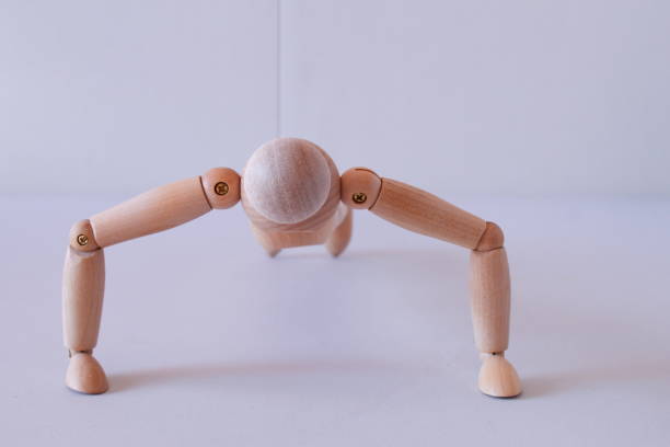 istock Wooden figure as a model for exercising at home 1367546687