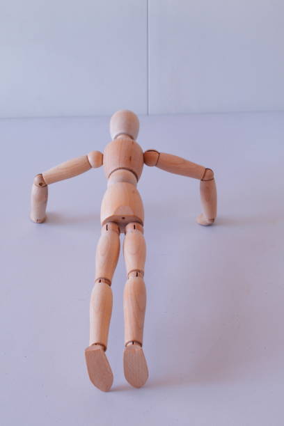 istock Wooden figure as a model for exercising at home 1367546748