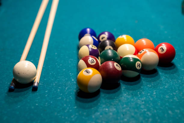 istock Billiard cue and colour balls on snooker table while game 1367547146