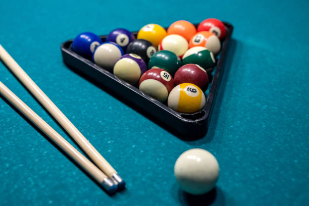 istock Billiard cue and colour balls on snooker table while game 1367548336