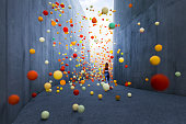 Woman walking in abstract concrete corridor