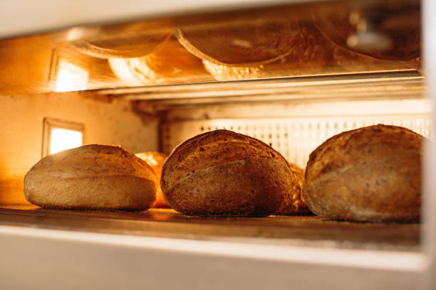 istock Bread is baked in the oven. Bakery concept. 1367549958