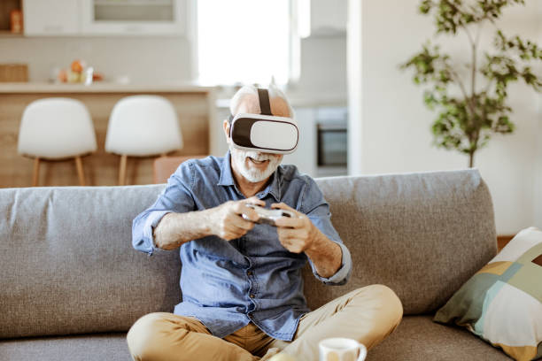 istock Bearded Senior Man Enjoying Virtual Reality Glasses 1367550045
