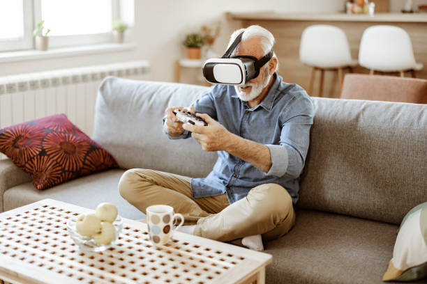 istock Bearded Senior Man Enjoying Virtual Reality Glasses 1367550211